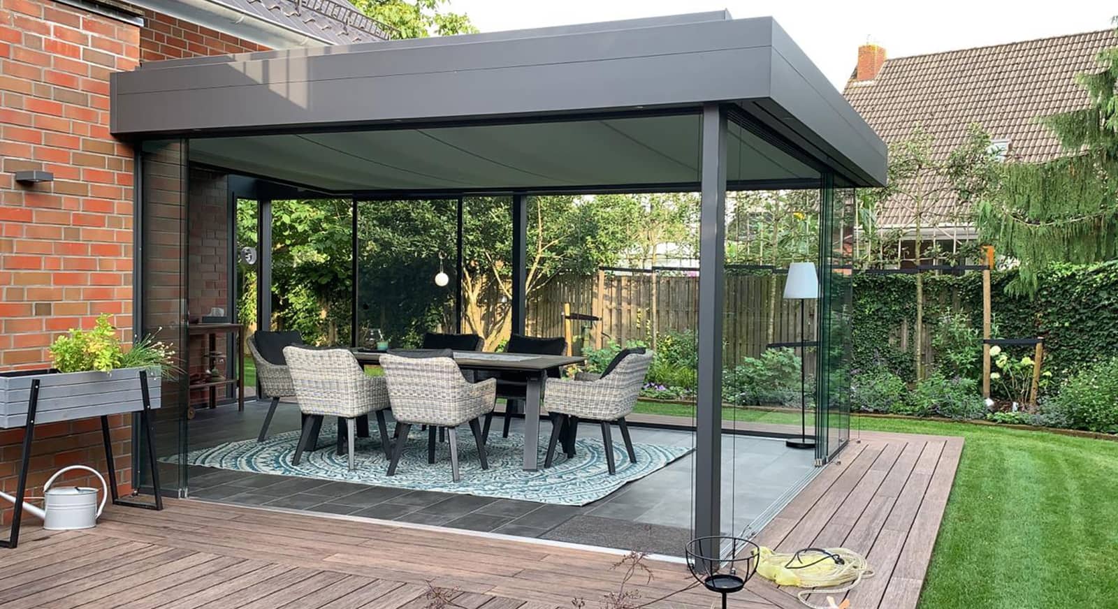 Wipro Sommergarten Lounge mit Glasschiebewänden und Essbereich auf der Terrasse